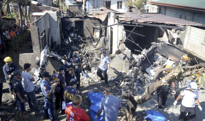 Philippines: 10 dead as small plane slams into house | AP Photo Philippines: 10 dead as small plane slams into house | AP Photo- India TV