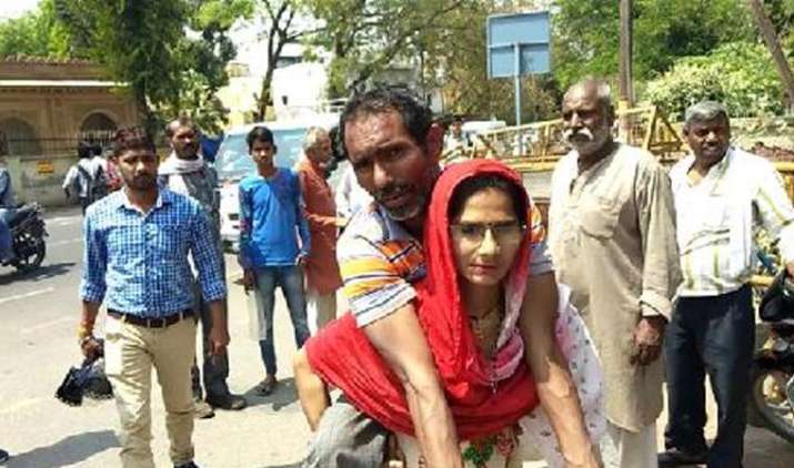 Woman in Mathura carries handicapped husband on shoulders to get disability certificate Woman in Mathura carries handicapped husband on shoulders to get disability certificate- India TV