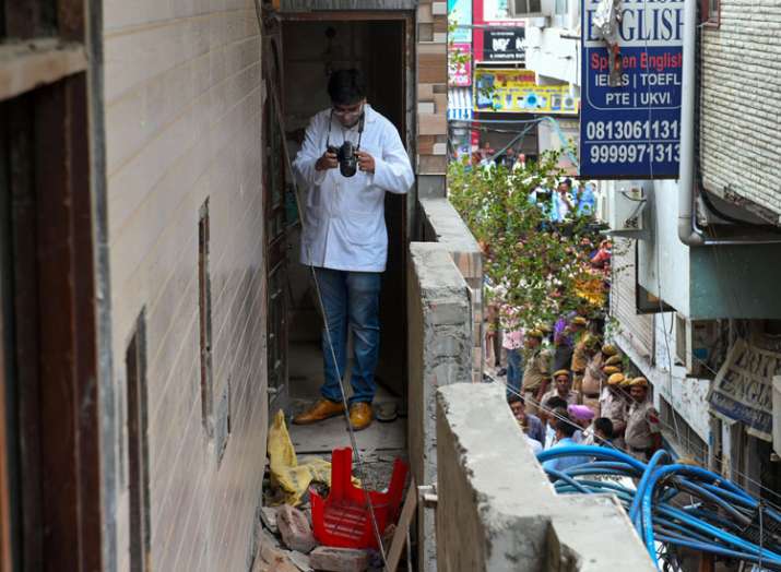 A forensic expert inspects the house, where 11 members... A forensic expert inspects the house, where 11 members...- India TV