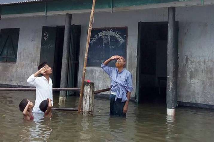 Boy who saluted Tricolour in chest-deep flood water not... Boy who saluted Tricolour in chest-deep flood water not...- India TV