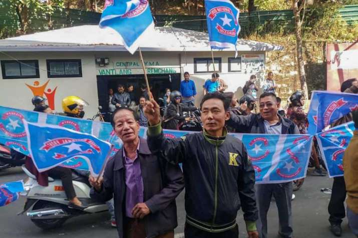 Mizo National Front (MNF) workers hold their party flag... Mizo National Front (MNF) workers hold their party flag...- India TV