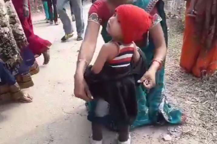 Crying toddler forced to remove black jacket before Sarbananda Sonowal rally Crying toddler forced to remove black jacket before Sarbananda Sonowal rally- India TV