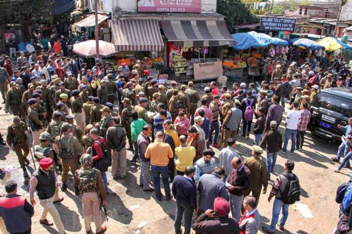 Police personnel inspect the site after a powerful... Police personnel inspect the site after a powerful...- India TV
