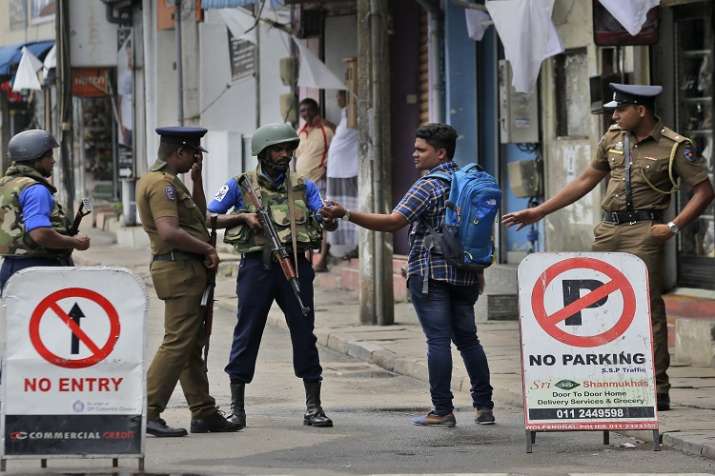 Sri Lankan policemen check the identity card of a person... Sri Lankan policemen check the identity card of a person...- India TV