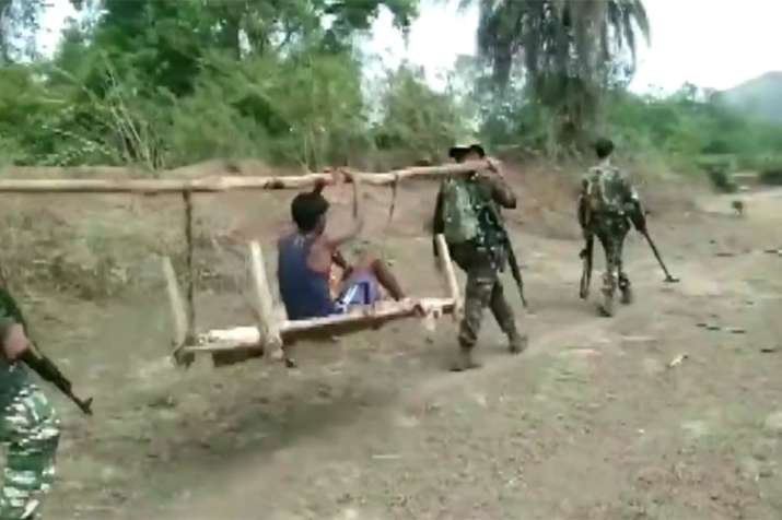 CRPF found a severely ill boy in a Chhattisgarh village and carried him on a cot for 8 km for treatm CRPF found a severely ill boy in a Chhattisgarh village and carried him on a cot for 8 km for treatm- India TV