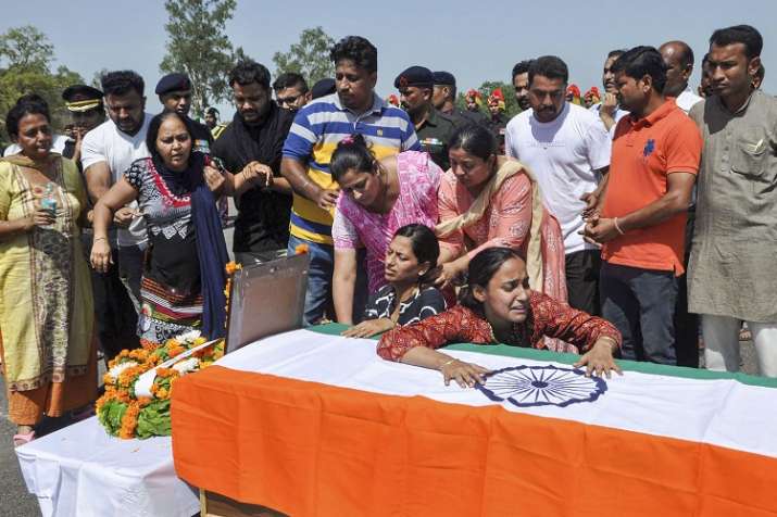 Family member mourns near the coffin of Major Ketan Sharma. Family member mourns near the coffin of Major Ketan Sharma.- India TV