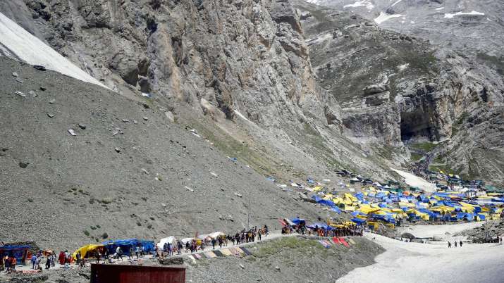 Hindu devotees on their way to the holy cave shrine of... Hindu devotees on their way to the holy cave shrine of...- India TV