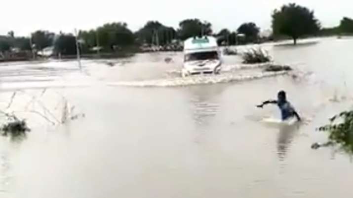 The 12-year-old braveheart puts his life in danger to lead an ambulance through a flood bridge in Ra The 12-year-old braveheart puts his life in danger to lead an ambulance through a flood bridge in Ra- India TV