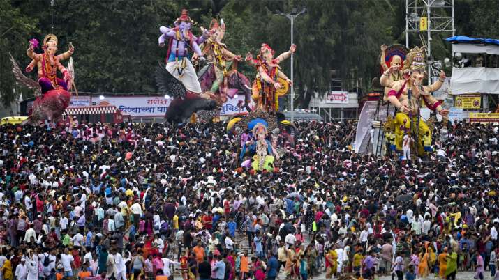 Devotees carry Ganesha idols for immersion to mark the end of Ganesh Utsav celebrations, at Girgaum Devotees carry Ganesha idols for immersion to mark the end of Ganesh Utsav celebrations, at Girgaum- India TV