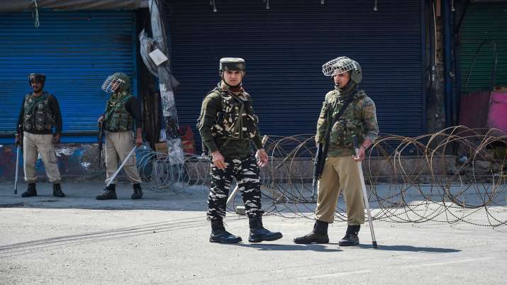 Security personnel stand guard during restrictions in Srinagar. Security personnel stand guard during restrictions in Srinagar.- India TV