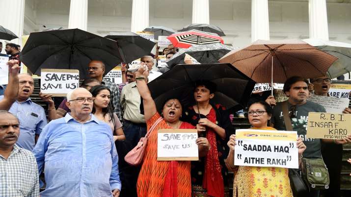 Depositors of the Punjab and Maharashtra Co-operative Bank (PMC) display placards during a protest o Depositors of the Punjab and Maharashtra Co-operative Bank (PMC) display placards during a protest o- India TV Paisa