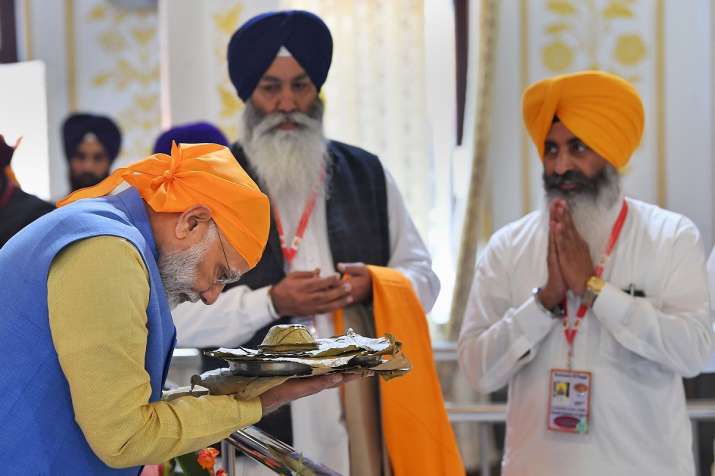 Prime Minister Narendra Modi receives 'parsad' after... Prime Minister Narendra Modi receives 'parsad' after...- India TV